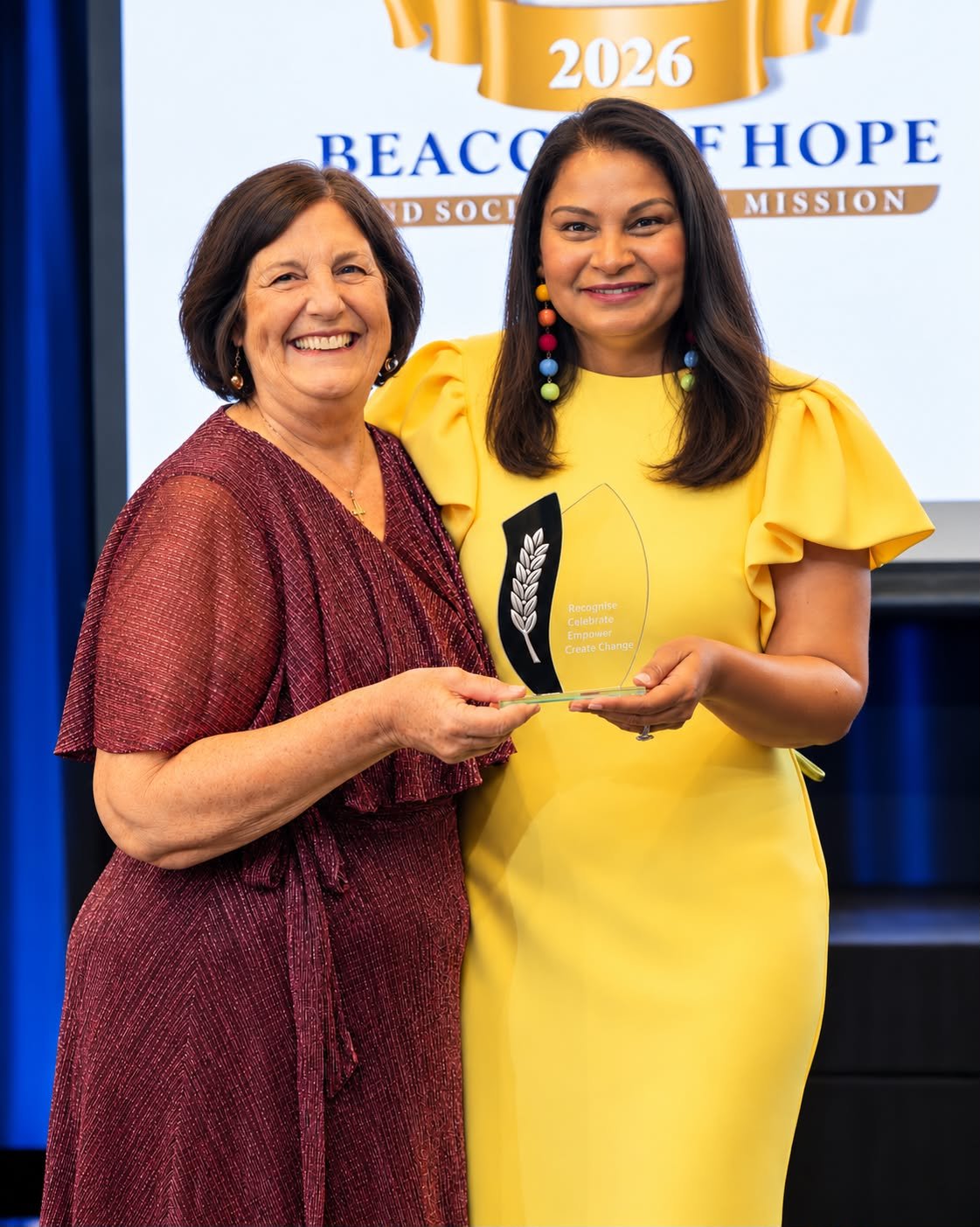 Beacon of Hope Mission Awards founder, Kelly Markey (right) with one of the award recipients