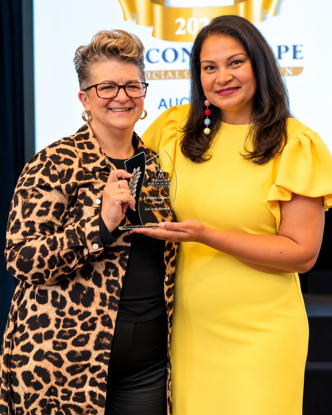 Beacon of Hope Mission Awards founder, Kelly Markey (right) with one of the award recipients